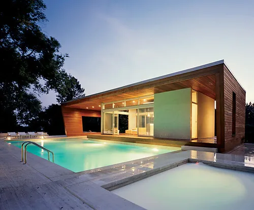 Modern villa with swimming pool at dusk